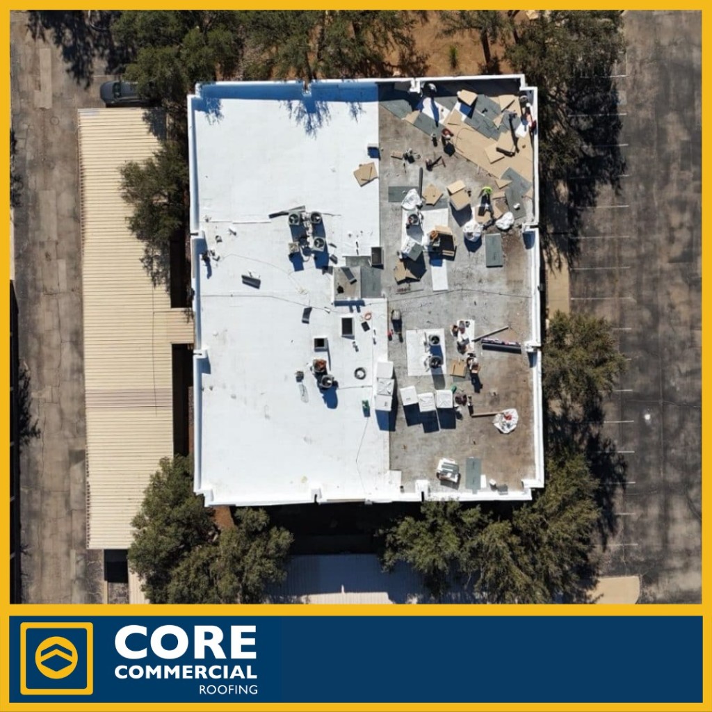 Aerial view of a fully adhered TPO overlay going over an existing built-up smooth roof