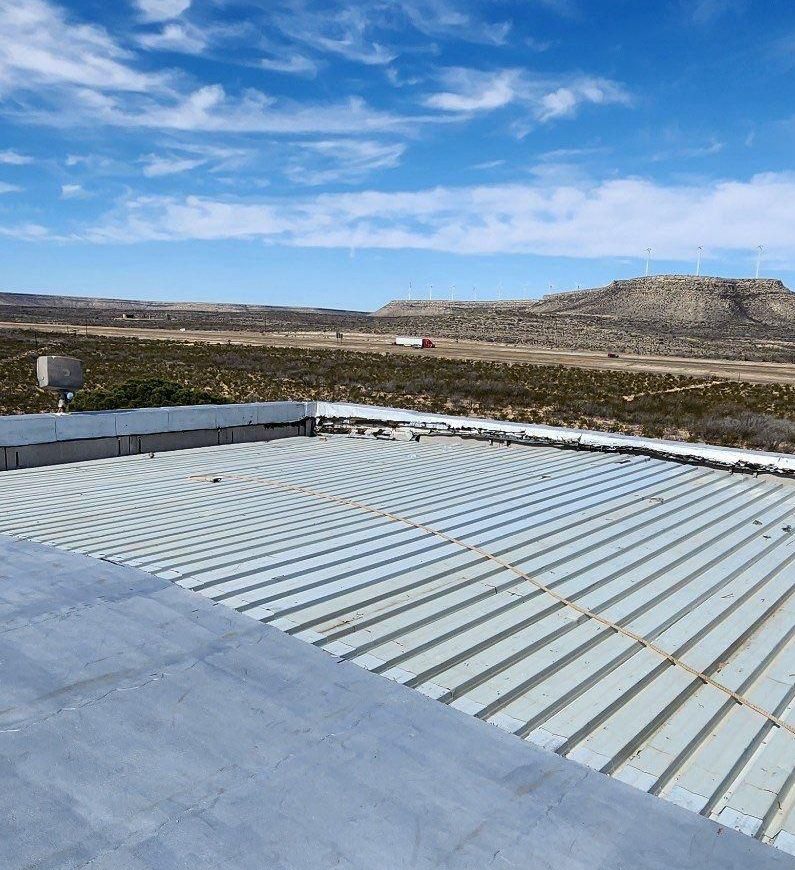 Smooth surface of an APP modified bitumen membrane on a heavy-traffic commercial roof in Lubbock, seams visible